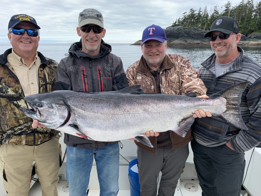 Guest holding king salmon caught on a Ketchikan Alaska fishing charter