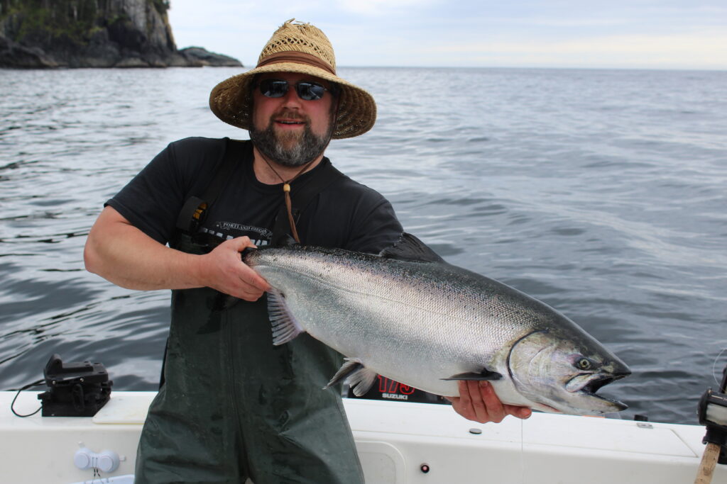 Family holding salmon on a fishing charter in Ketchikan Alaska