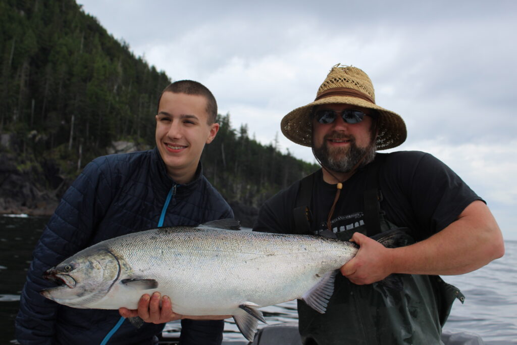 Family holding salmon on a fishing charter in Ketchikan Alaska