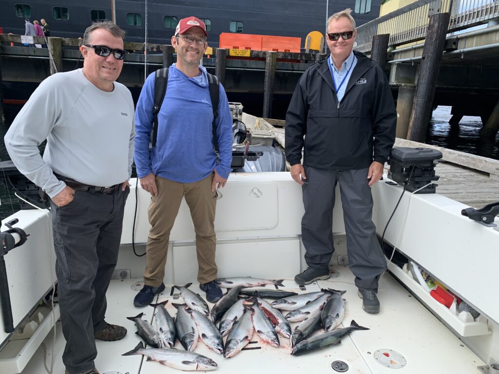 Guest with salmon caught on a 4 hour cruise ship fishing charter in Ketchikan Alaska height=