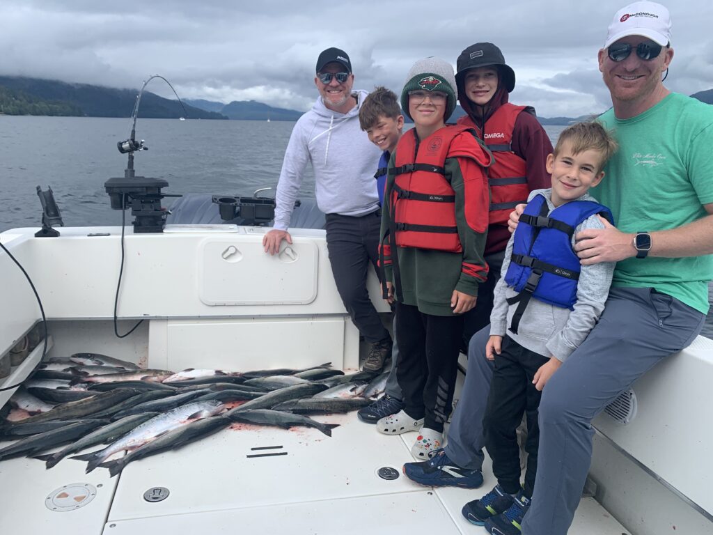 Guest with salmon caught on a 4 hour cruise ship fishing charter in Ketchikan Alaska height=