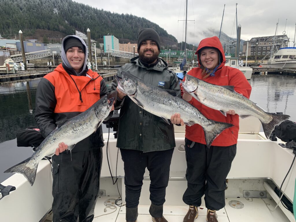 Family holding winter king salmon caught on a Ketchikan Alaska fishing charter