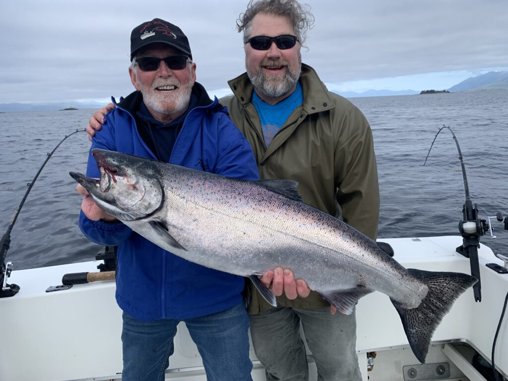 Guest holding king salmon caught on a Ketchikan Alaska fishing charter