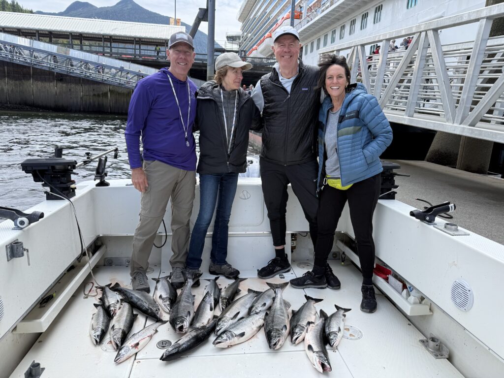Guest with salmon caught on a 4 hour cruise ship fishing charter in Ketchikan Alaska height=