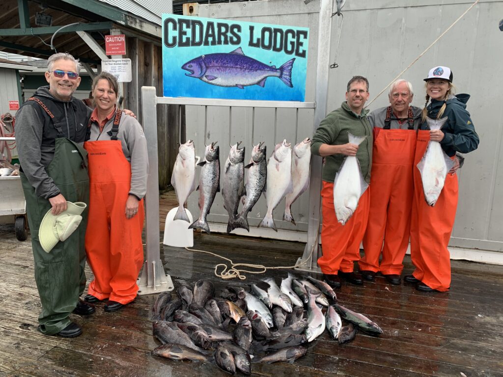 Guest with salmon and bottom fish caught on a Ketchikan Alaska fishing charter with Campbell's fishing charters