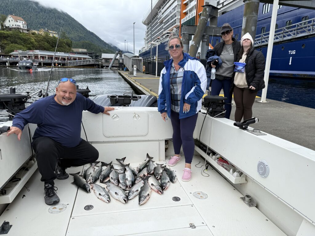 Happy fishermen with salmon catch at Berth 3 Downtown Ketchikan Alaska