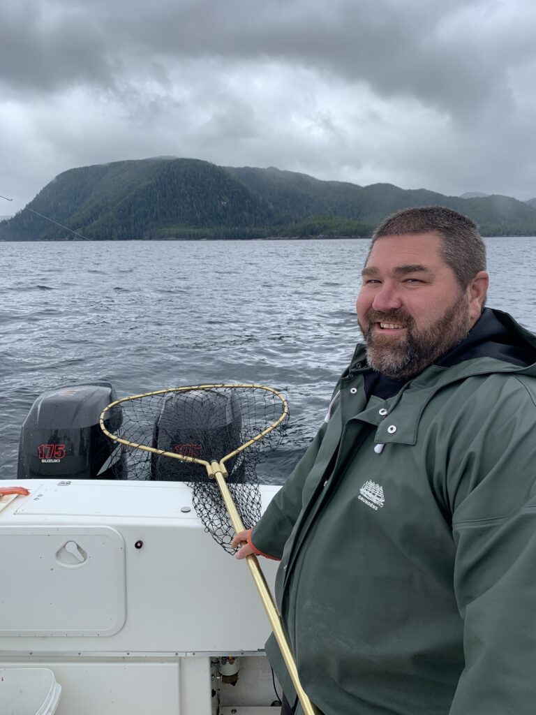 Captain Cable netting a salmon on the deck of the 4 C’s with Campbell’s Fishing Charters.