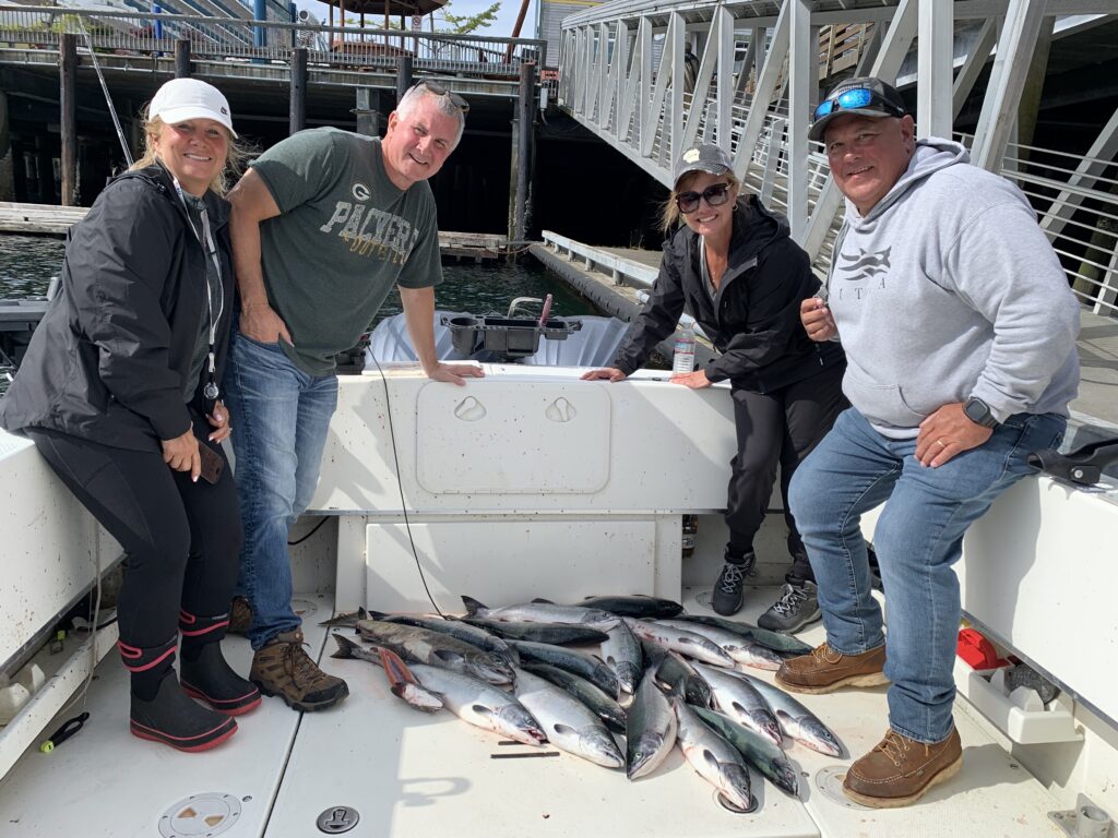 Happy cruise ship fishermen after 4 hour salmon charter in downtown Ketchikan Alaska Berth 1