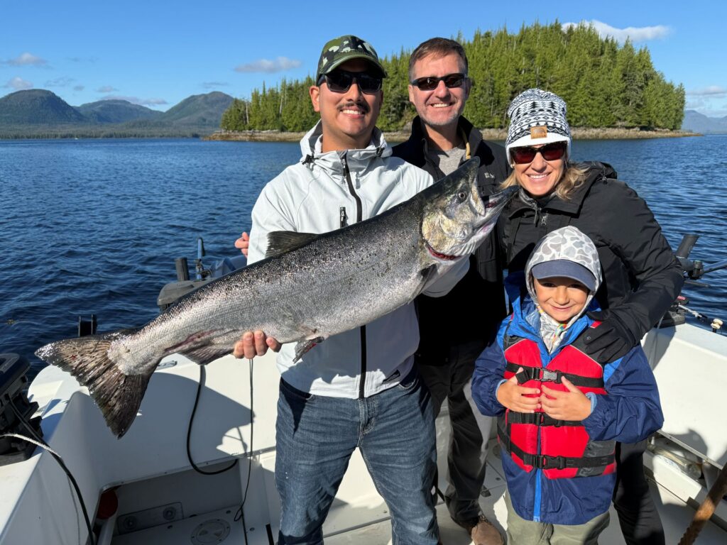 Ketchikan salmon fishing report showing a happy group with an Alaskan salmon.